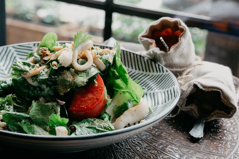 Delicious Starter With Spinach Leaves And Squid On Ceramic