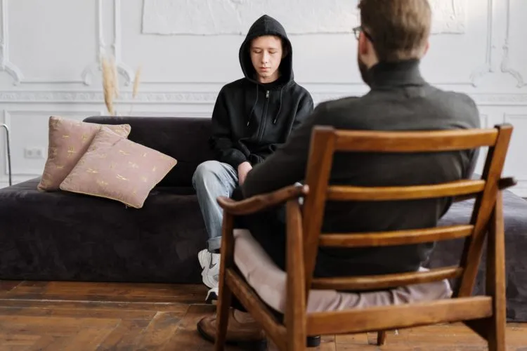 Woman In Black Hijab Sitting On Brown Wooden Armchair 4100650
